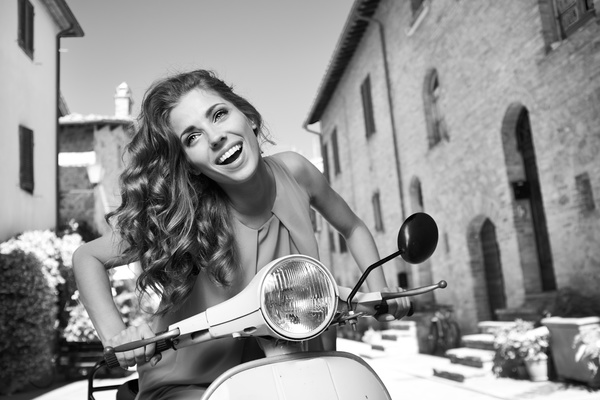 Black and white photo of girl riding a motorbike Stock Photo