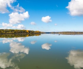 Blue sky white clouds lake reflection Stock Photo