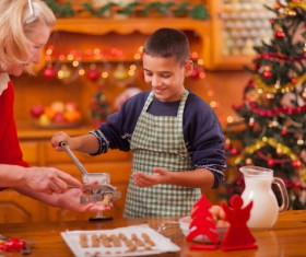 oy who makes food with his grandmother Stock Photo
