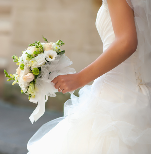 Bride holding bouquet of flowers Stock Photo