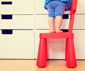Children standing on chairs Stock Photo