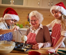 Children who make Christmas food with their grandmother Stock Photo