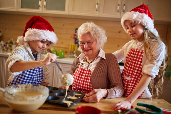 Children who make Christmas food with their grandmother Stock Photo
