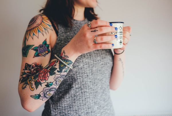 Color tattoo on the arm of a woman Stock Photo