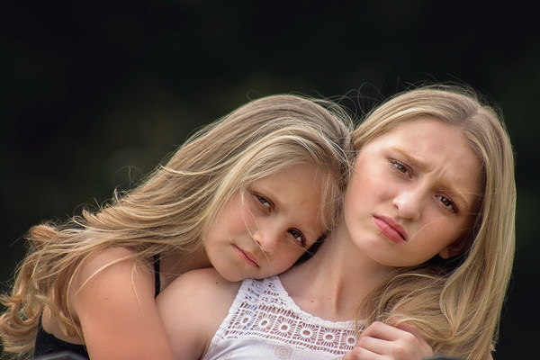 Cuddling sisters Stock Photo