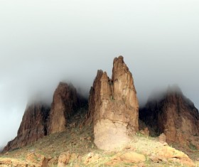 Fog covering rocky mountain Stock Photo