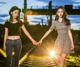 Good friends walking on the rails in hand Stock Photo