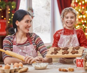 Happy daughter and mother making Christmas food Stock Photo