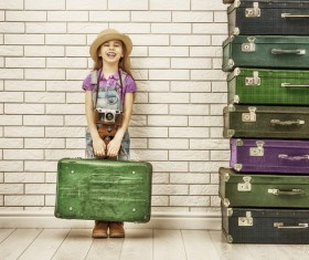 Happy little girl holding a suitcase Stock Photo
