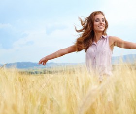 Happy woman in the field Stock Photo