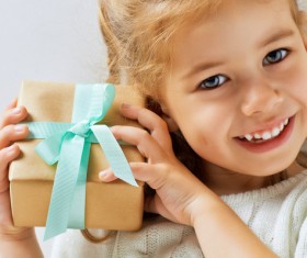 Holding a gift box happy little girl Stock Photo 01
