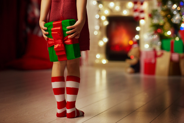 Little girl holding gift box on Christmas night Stock Photo