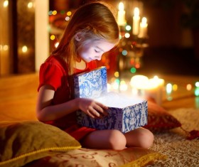 Little girl opening Christmas gift Stock Photo
