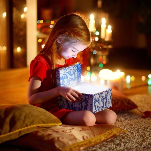 Little girl opening Christmas gift Stock Photo