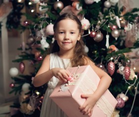 Little girl receiving gifts on Christmas Day Stock Photo 01