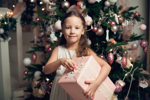Little girl receiving gifts on Christmas Day Stock Photo 01