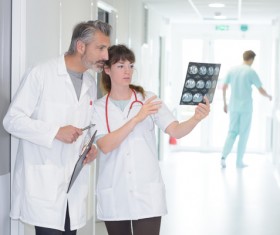 Male and female doctors to see X-ray film Stock Photo