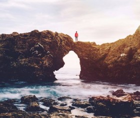 Man standing on beach reef Stock Photo