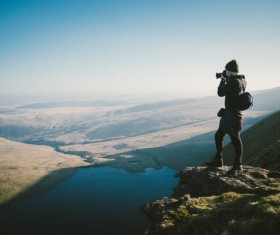 Man taking photo of beautiful natural scene Stock Photo