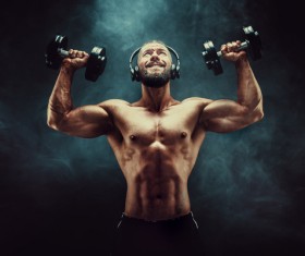 Men lifting dumbbells with headphones