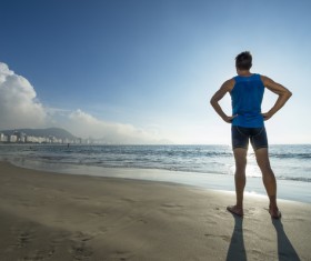 Men looking into the distance on the beach Stock Photo