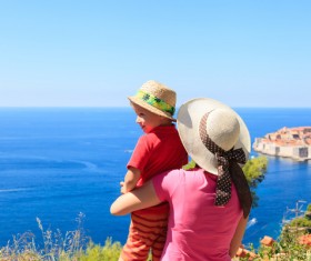 Mother watching the sea with her baby Stock Photo