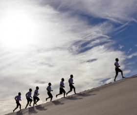 People running in the desert Stock Photo
