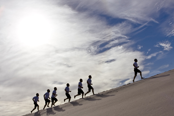People running in the desert Stock Photo