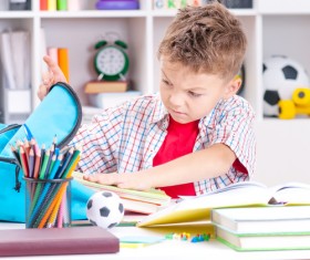 Pupils who take out books from their schoolbags Stock Photo