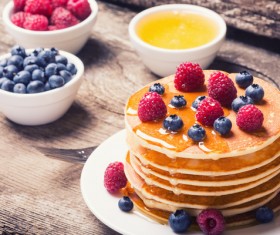 Raspberry blueberry pancakes with honey Stock Photo