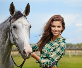 Smiling woman hold horse Stock Photo