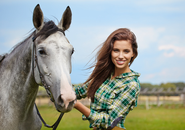 Smiling woman hold horse Stock Photo