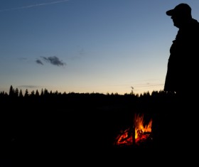 Standing next to the campfire Stock Photo