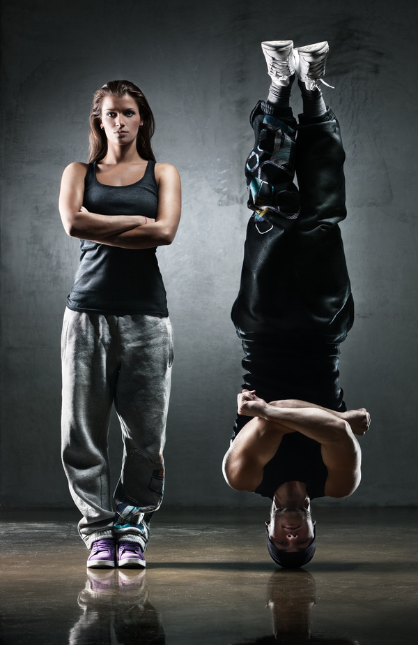 Standing woman with handstand man Stock Photo