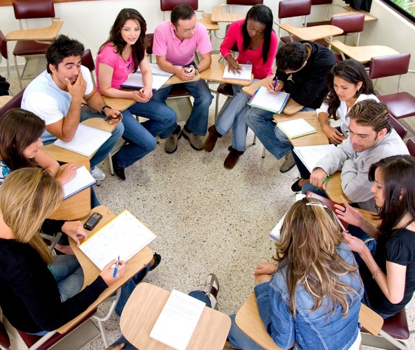 Students sit around talking together Stock Photo