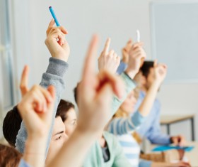 Students who raise their hands in class Stock Photo
