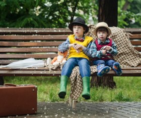 The children sat on the roadside bench Stock Photo