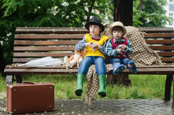 The children sat on the roadside bench Stock Photo