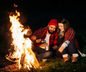The couple next to the campfire Stock Photo