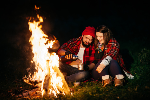The couple next to the campfire Stock Photo