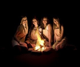 The girls around the campfire Stock Photo