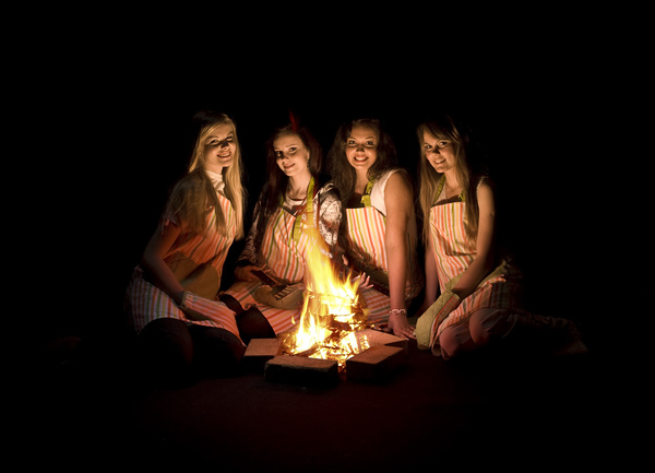 The girls around the campfire Stock Photo