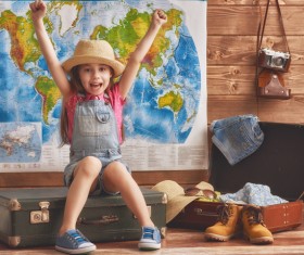 The little girl sitting on the table Stock Photo