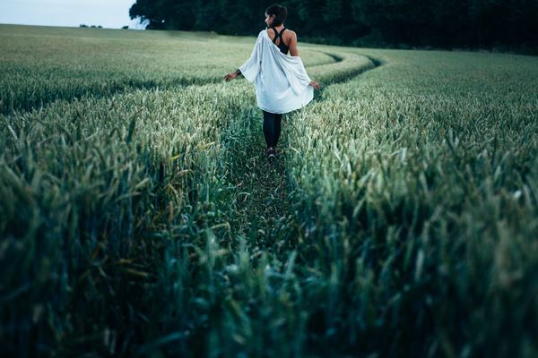 Walking in the green wheat field girl Stock Photo