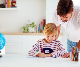 Watching children write homework father Stock Photo
