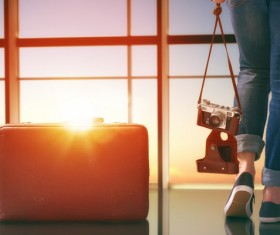 Woman holding camera and travel bag Stock Photo