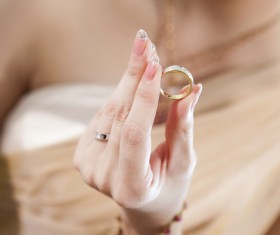 Woman holding wedding ring in hand Stock Photo