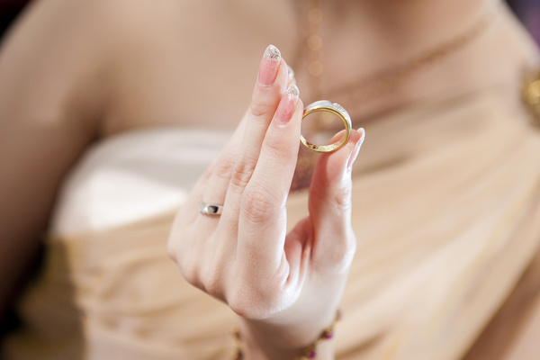 Woman holding wedding ring in hand Stock Photo