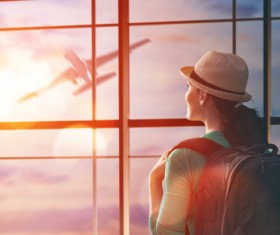 Woman looking at air plane Stock Photo