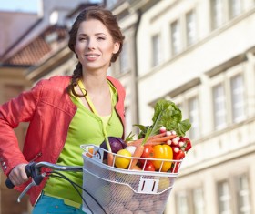 Woman riding a bike to buy food Stock Photo